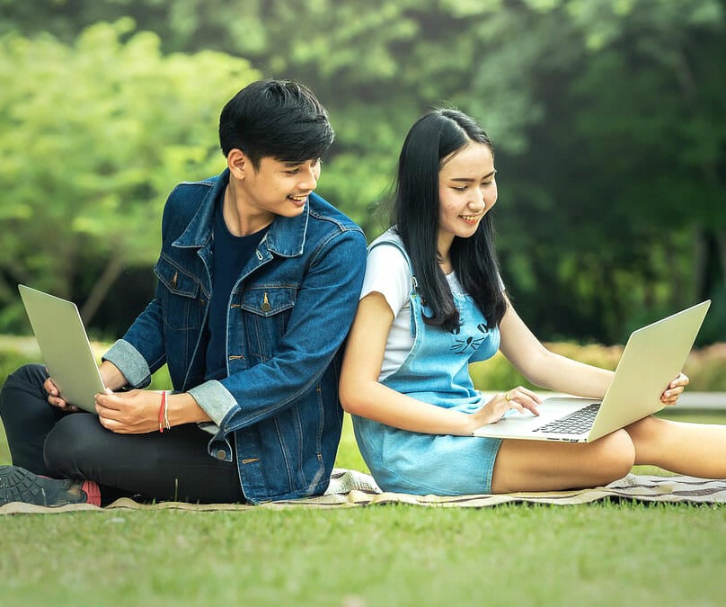 International students studying on laptops